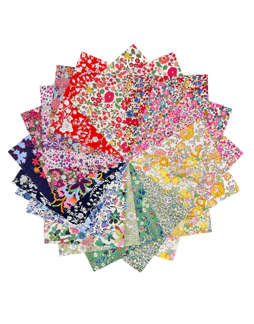 Stack of colorful floral fabric swatches on a white background